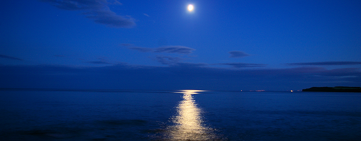 Moonlight reflections in Lyme Bay, Sidmouth on a still, clear July evening.